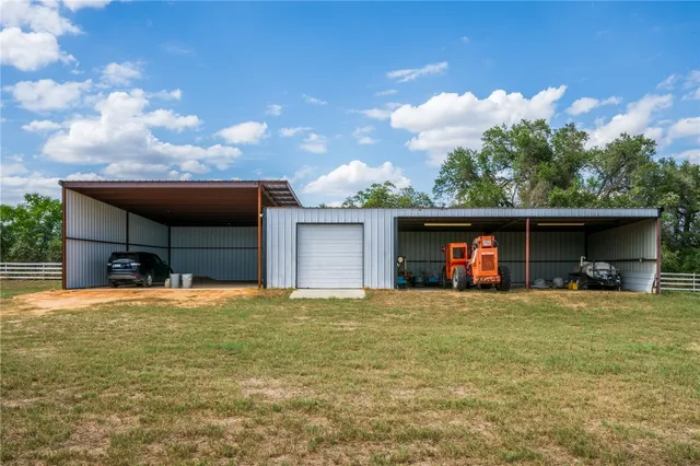 a view of a house with swimming pool and sitting area