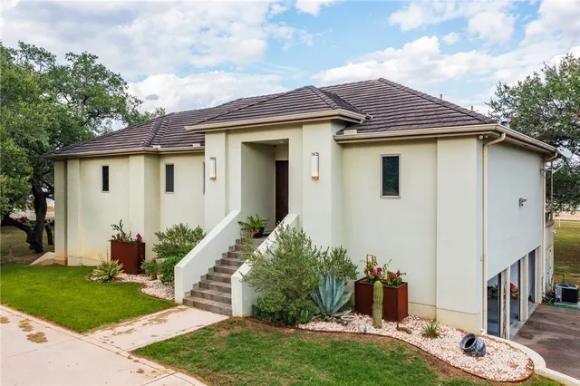 a front view of a house with a garden