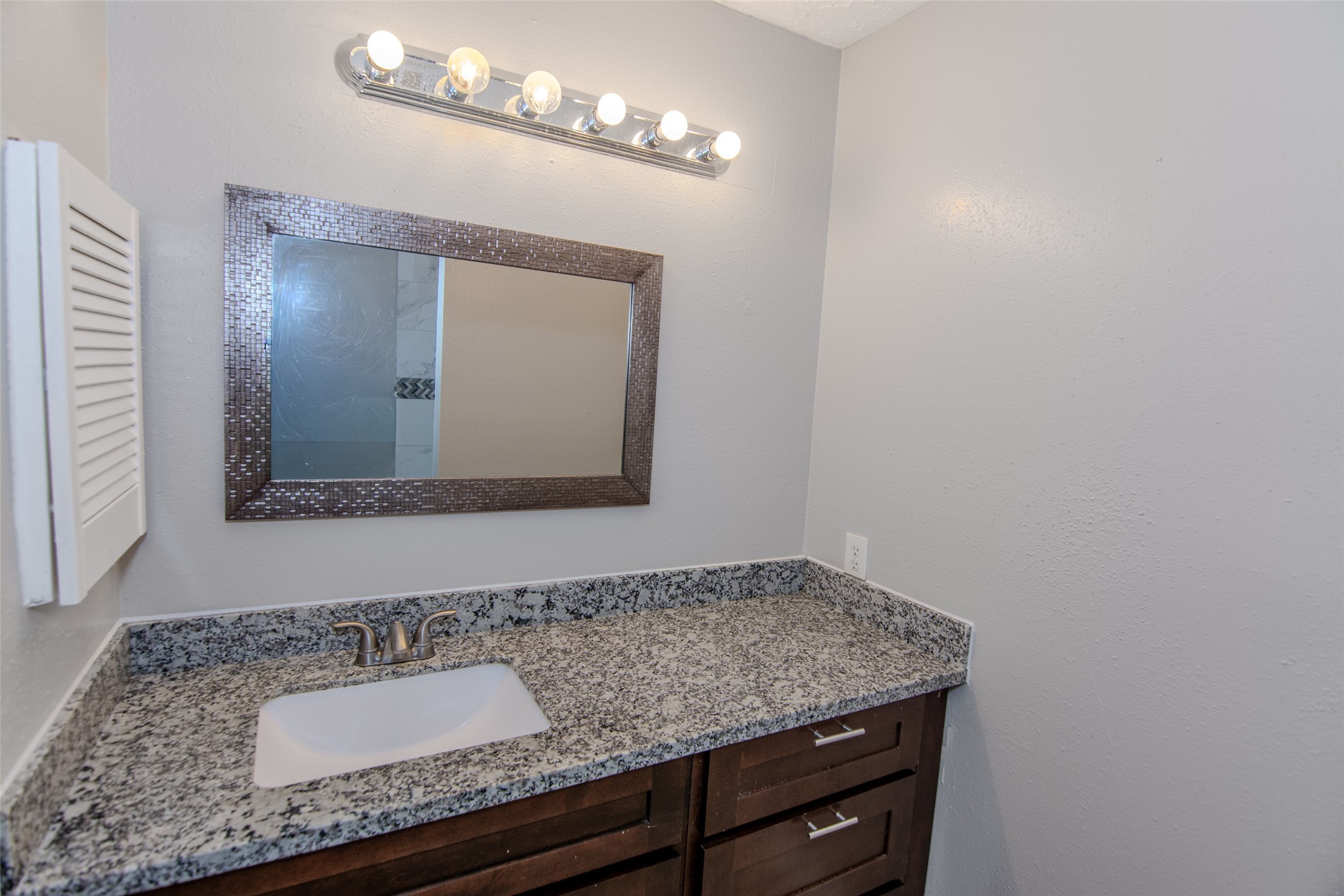 20031 Woodhall Lane Humble, TX 77338 - Photo 12 of 16 a bathroom with a granite countertop sink and a mirror