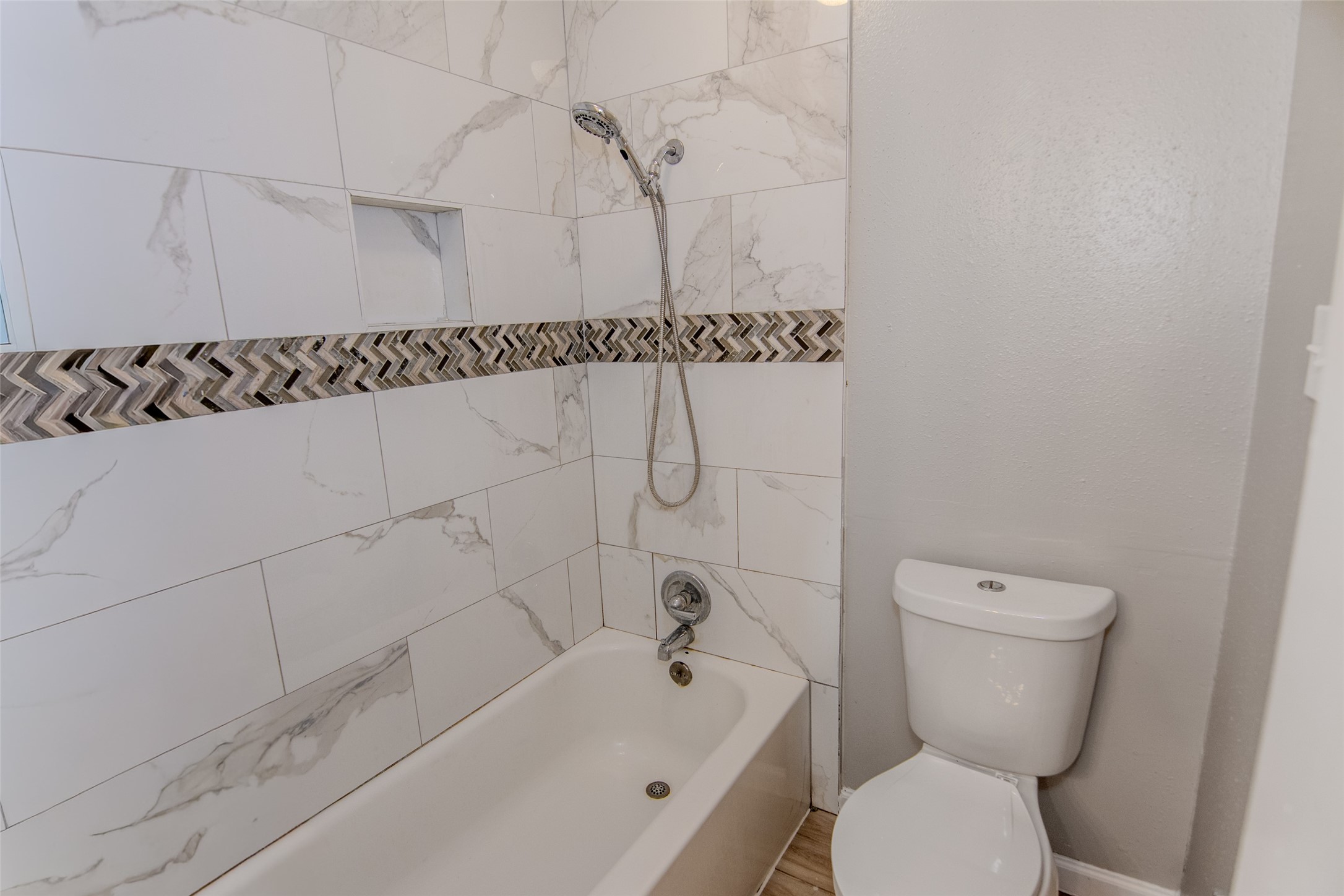 20031 Woodhall Lane Humble, TX 77338 - Photo 13 of 16 a bathroom with a toilet and a bathtub