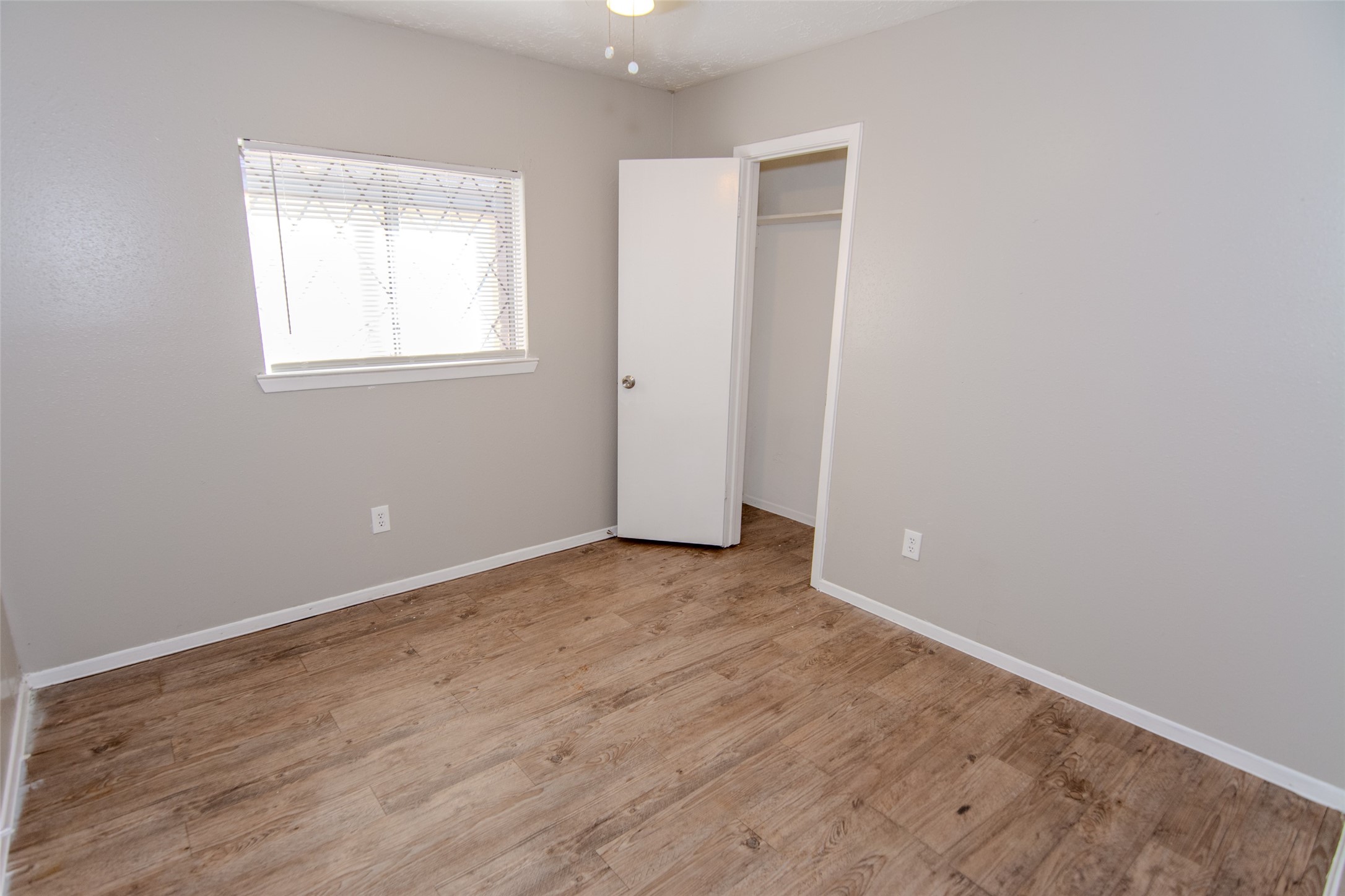 20031 Woodhall Lane Humble, TX 77338 - Photo 14 of 16 an empty room with wooden floor and windows