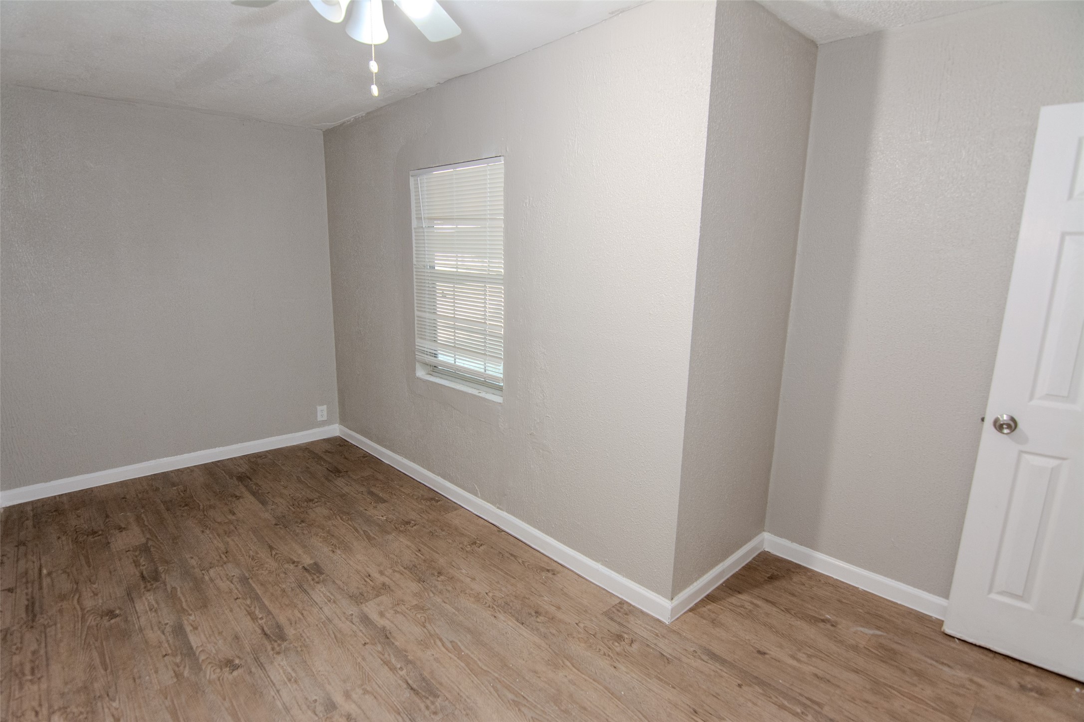 20031 Woodhall Lane Humble, TX 77338 - Photo 9 of 16 an empty room with wooden floor and windows