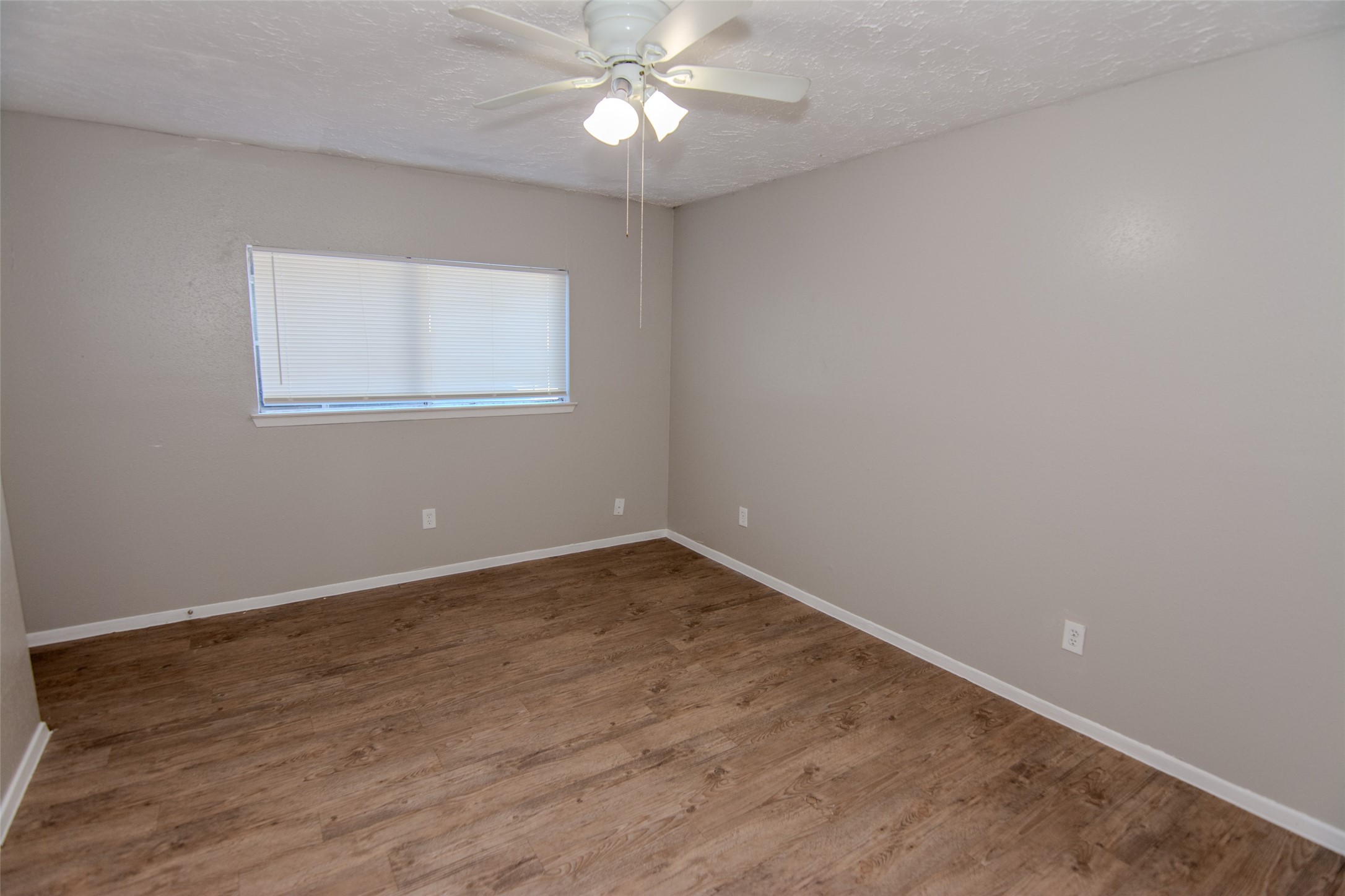 20031 Woodhall Lane Humble, TX 77338 - Photo 10 of 16 an empty room with a window and a fan