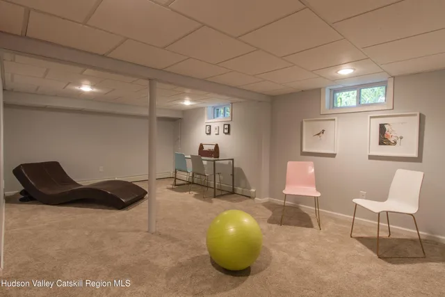 a bedroom with a bed a couch and a window