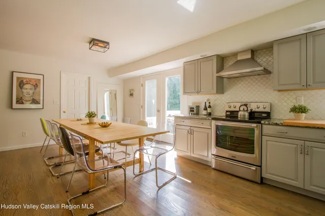 a kitchen with stainless steel appliances a stove a sink and a refrigerator