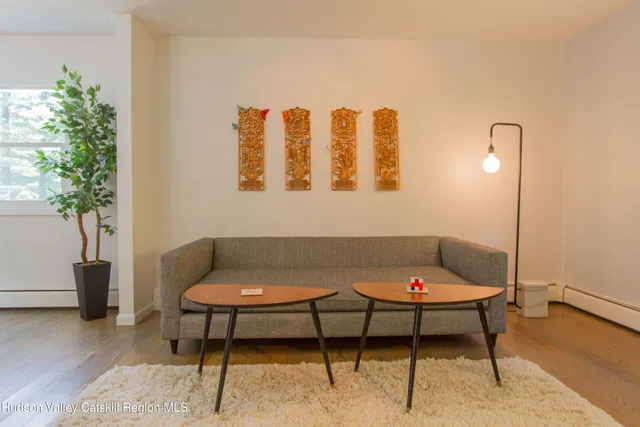 a living room with a couch and a potted plant