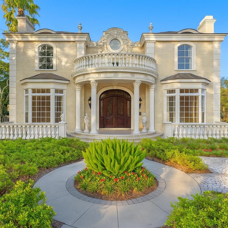 1577 Alexander Road Belleair, FL 33756 - Photo 1 of 65 a view of a house with a garden