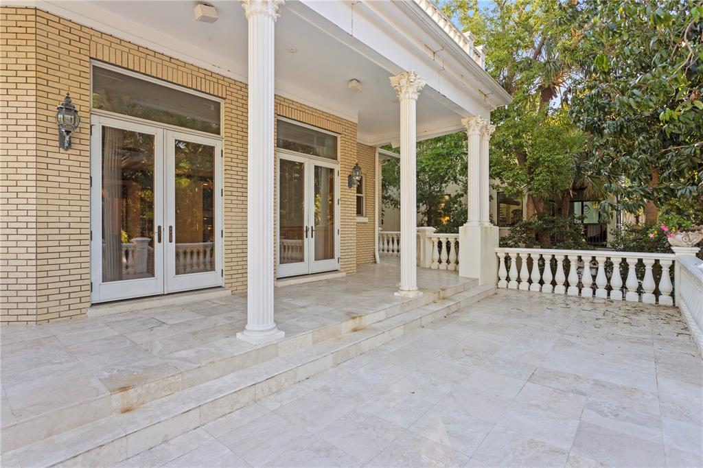 1577 Alexander Road Belleair, FL 33756 - Photo 16 of 65 front view of a house with a porch