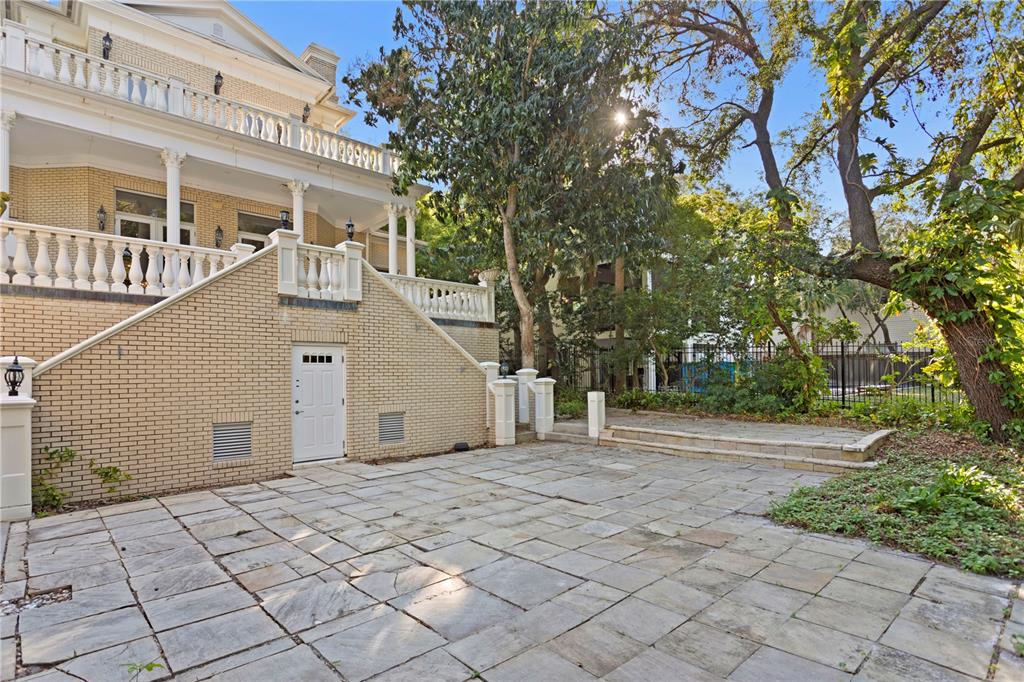 1577 Alexander Road Belleair, FL 33756 - Photo 18 of 65 a front view of a house with a yard and trees