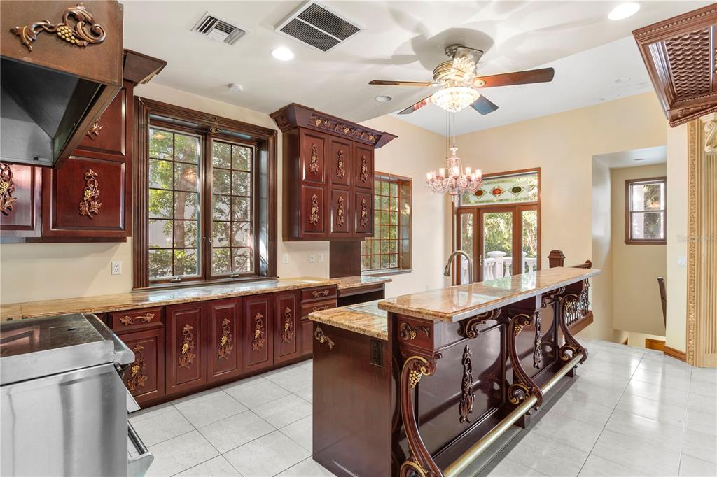 1577 Alexander Road Belleair, FL 33756 - Photo 22 of 65 a kitchen with stainless steel appliances granite countertop a stove and a sink