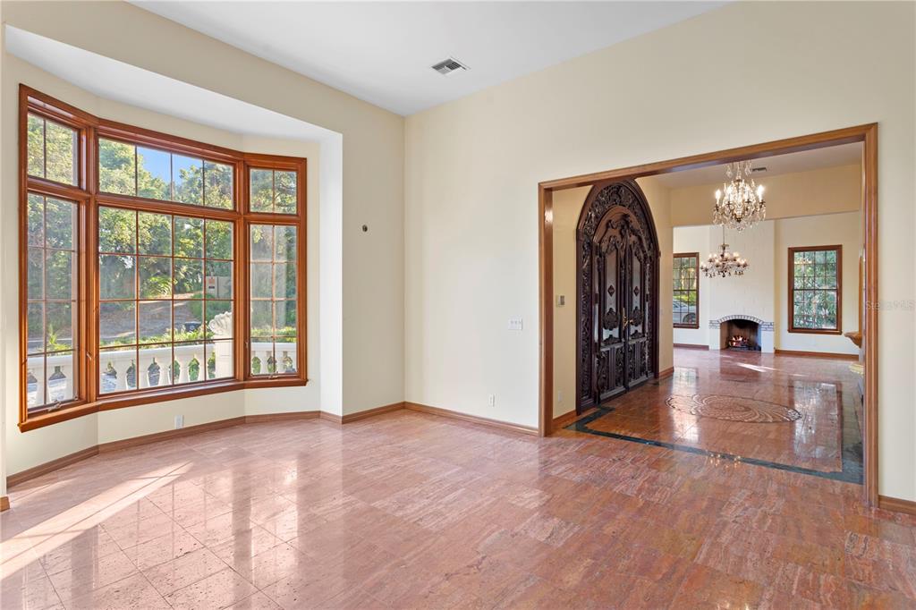 1577 Alexander Road Belleair, FL 33756 - Photo 24 of 65 a view of a big room with windows and wooden floor