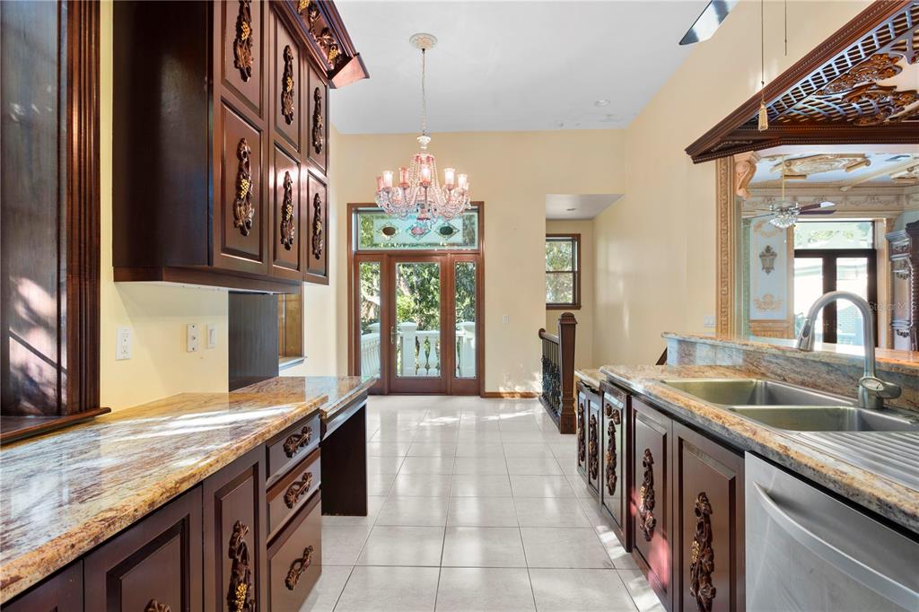 1577 Alexander Road Belleair, FL 33756 - Photo 31 of 65 a kitchen with granite countertop a sink and cabinets