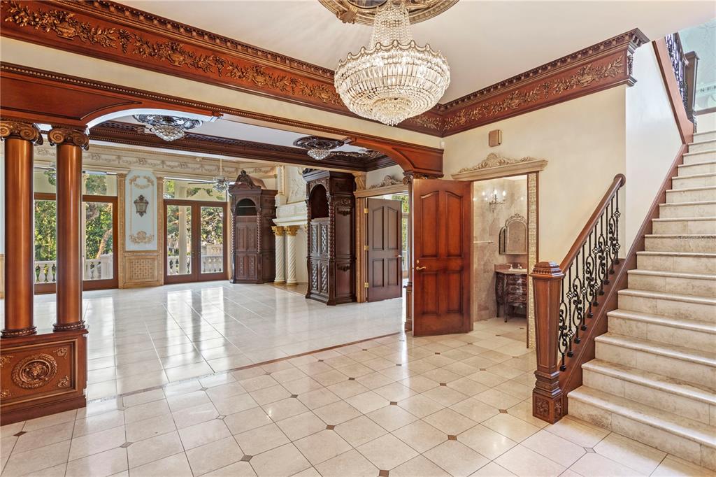 1577 Alexander Road Belleair, FL 33756 - Photo 37 of 65 a view of a hallway with entryway and chandelier