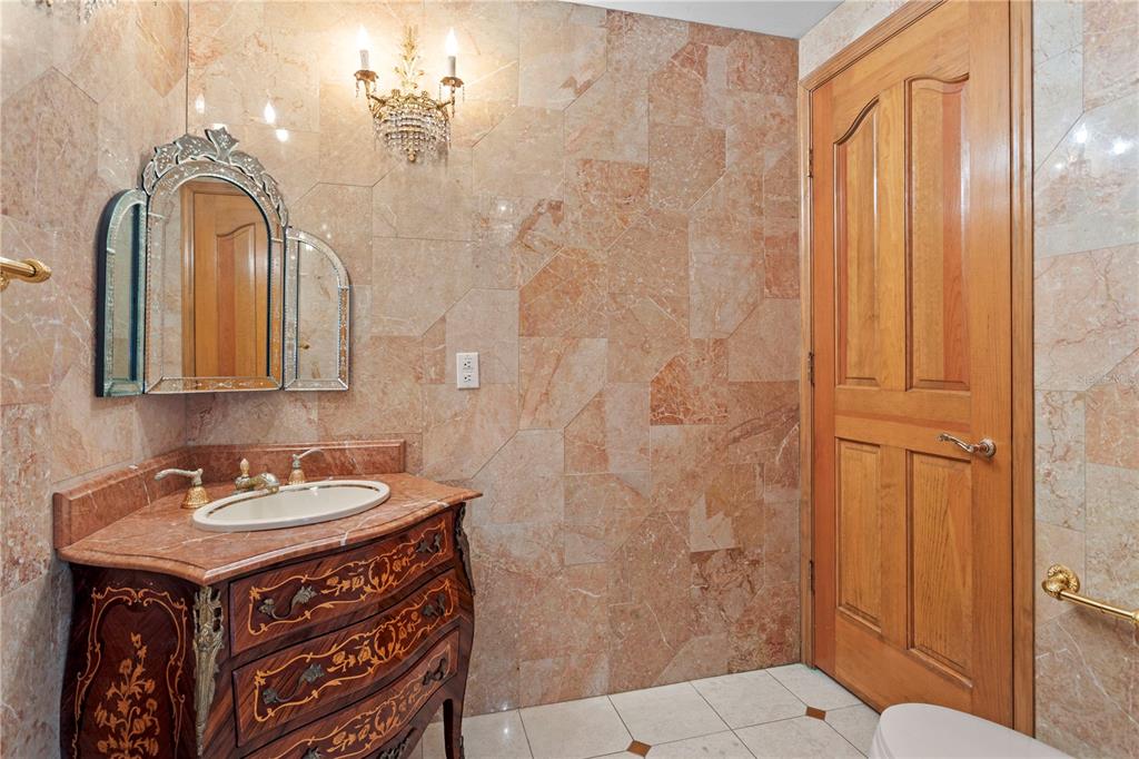 1577 Alexander Road Belleair, FL 33756 - Photo 38 of 65 a bathroom with a sink a toilet and a mirror