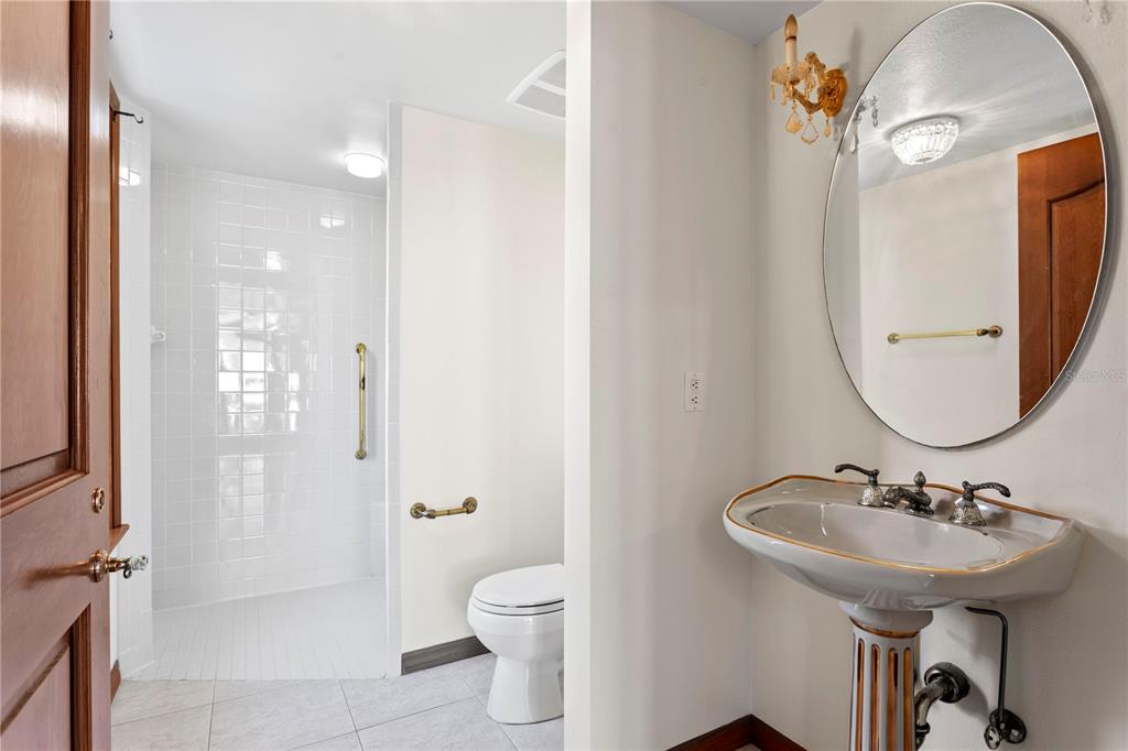 1577 Alexander Road Belleair, FL 33756 - Photo 42 of 65 a bathroom with a sink a toilet and shower