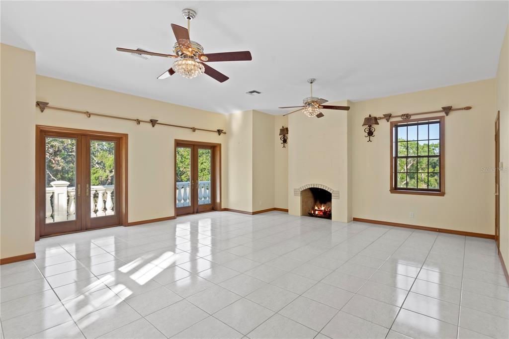 1577 Alexander Road Belleair, FL 33756 - Photo 53 of 65 a view of an empty room with window and fireplace