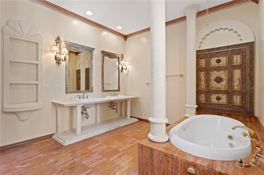 1577 Alexander Road Belleair, FL 33756 - Photo 59 of 65 a spacious bathroom with a double vanity sink a mirror and a bathtub