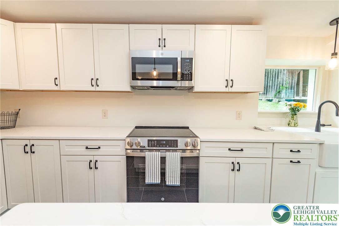 72 Allegheny Road Mount Bethel, PA 18343 - Photo 16 of 72 White cabinetry and stone counters define this well-appointed kitchen, ideal for culinary creations.