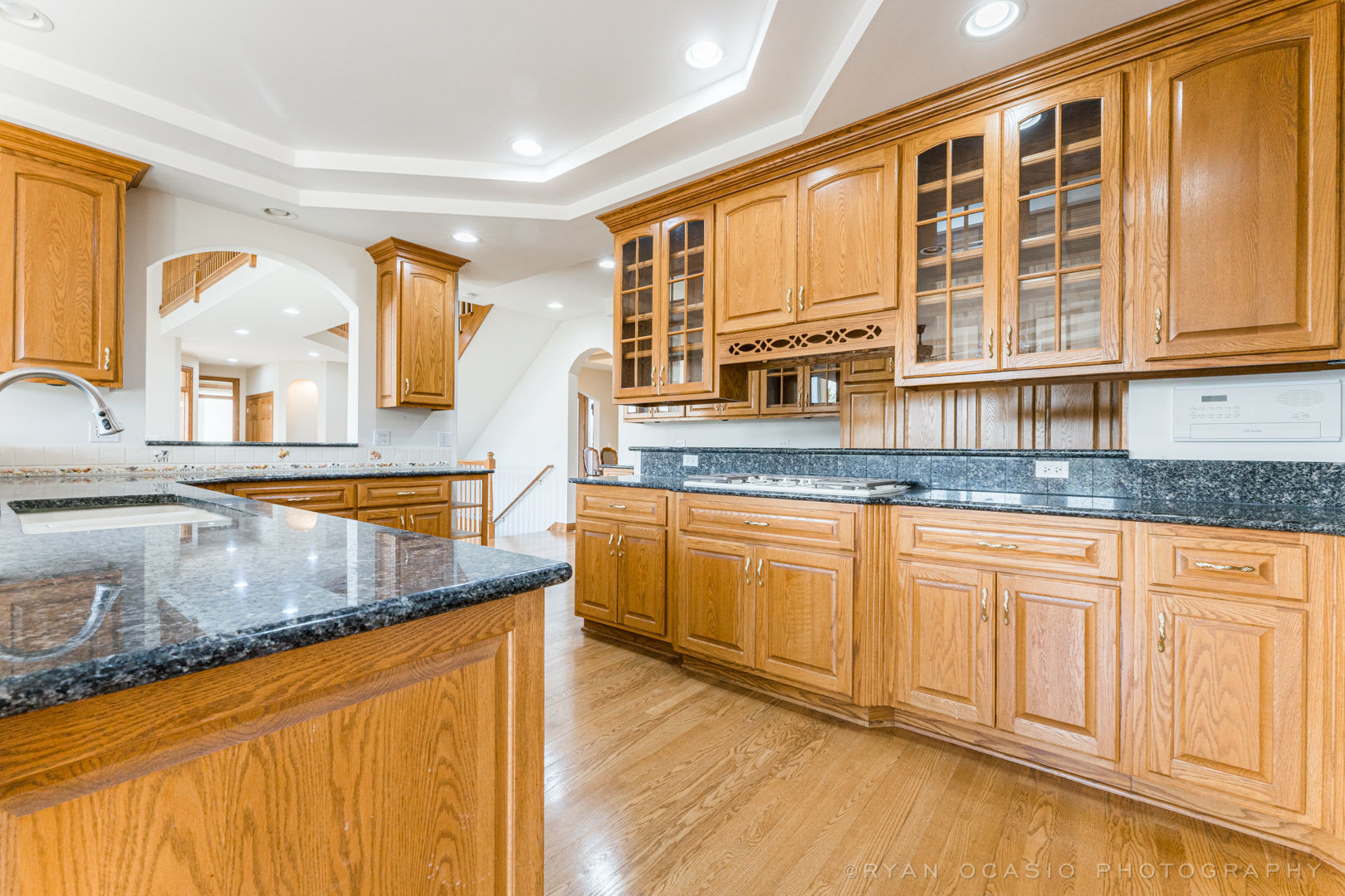 23374 West Milton Road Wauconda, IL 60084 - Photo 19 of 49 a kitchen with granite countertop wooden cabinets a sink and a window