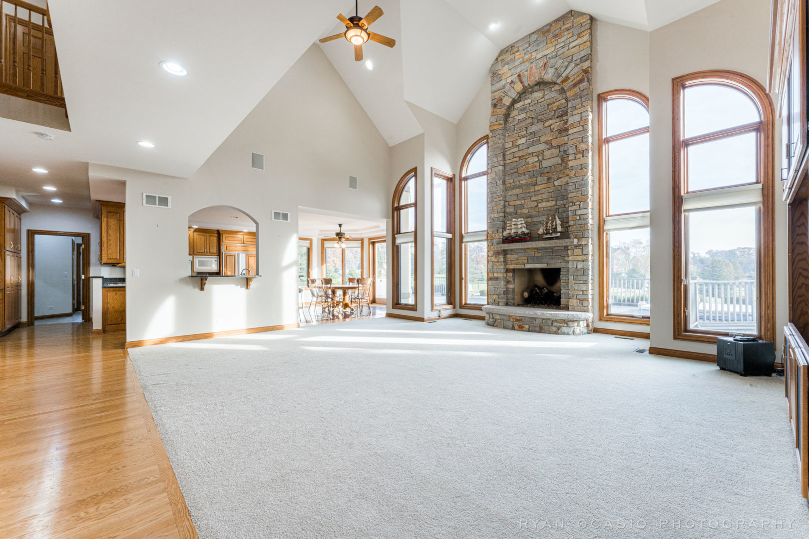 23374 West Milton Road Wauconda, IL 60084 - Photo 10 of 49 an empty room with fireplace windows and a chandelier