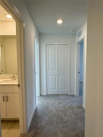 a view of a hallway with wooden shelves