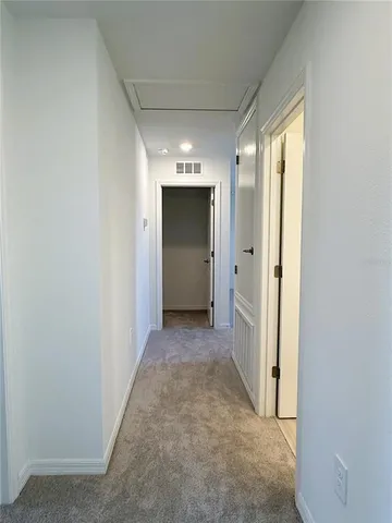 a view of an empty room and a window