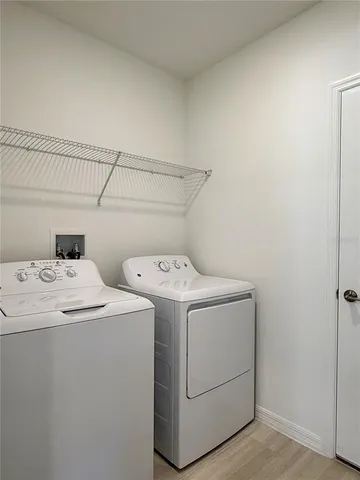a view of a house with wooden fence