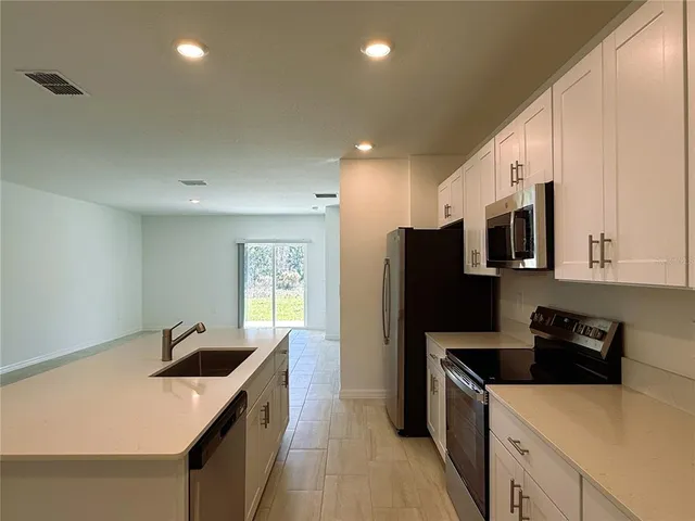 a kitchen that has a sink and a stove in it
