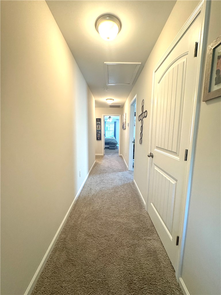 143 Adger Road Pendleton, SC 29670 - Photo 26 of 30 A long hallway connects private rooms over soft, neutral carpeting.