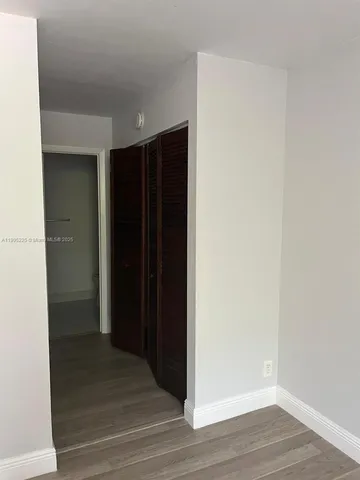 a view of hallway with wooden floor