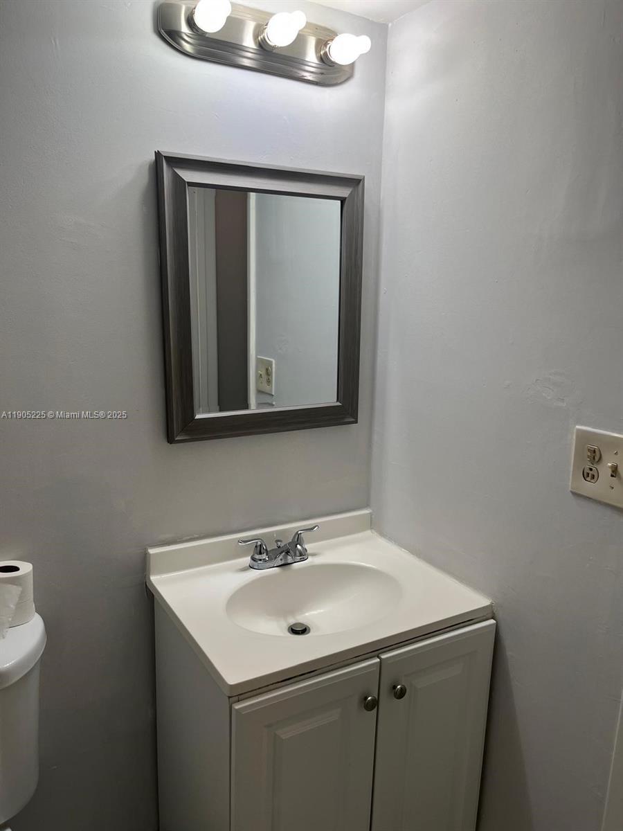 2701 Riverside Drive, Unit 203B Coral Springs, FL 33065 - Photo 15 of 18 a bathroom with a sink and a mirror