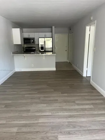 a view of a kitchen with microwave and cabinets