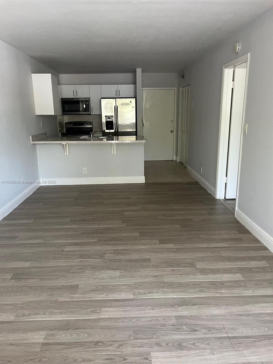 2701 Riverside Drive, Unit 203B Coral Springs, FL 33065 - Photo 16 of 18 a view of a kitchen with microwave and cabinets