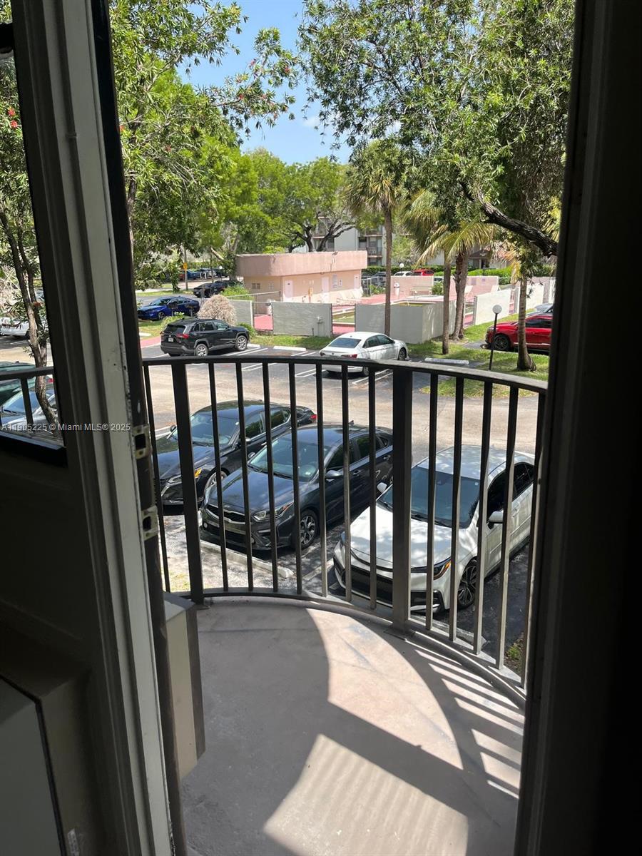 2701 Riverside Drive, Unit 203B Coral Springs, FL 33065 - Photo 17 of 18 a view of balcony with wooden floor and fence