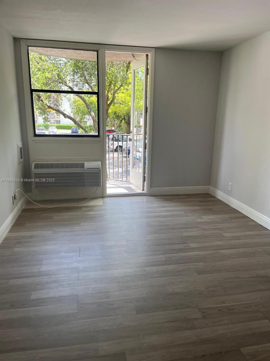 2701 Riverside Drive, Unit 203B Coral Springs, FL 33065 - Photo 3 of 18 a view of empty room with wooden floor and fan