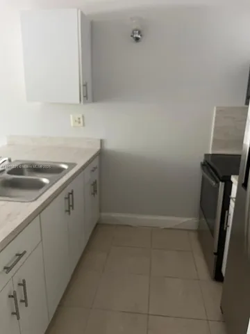 a kitchen with a sink and cabinets