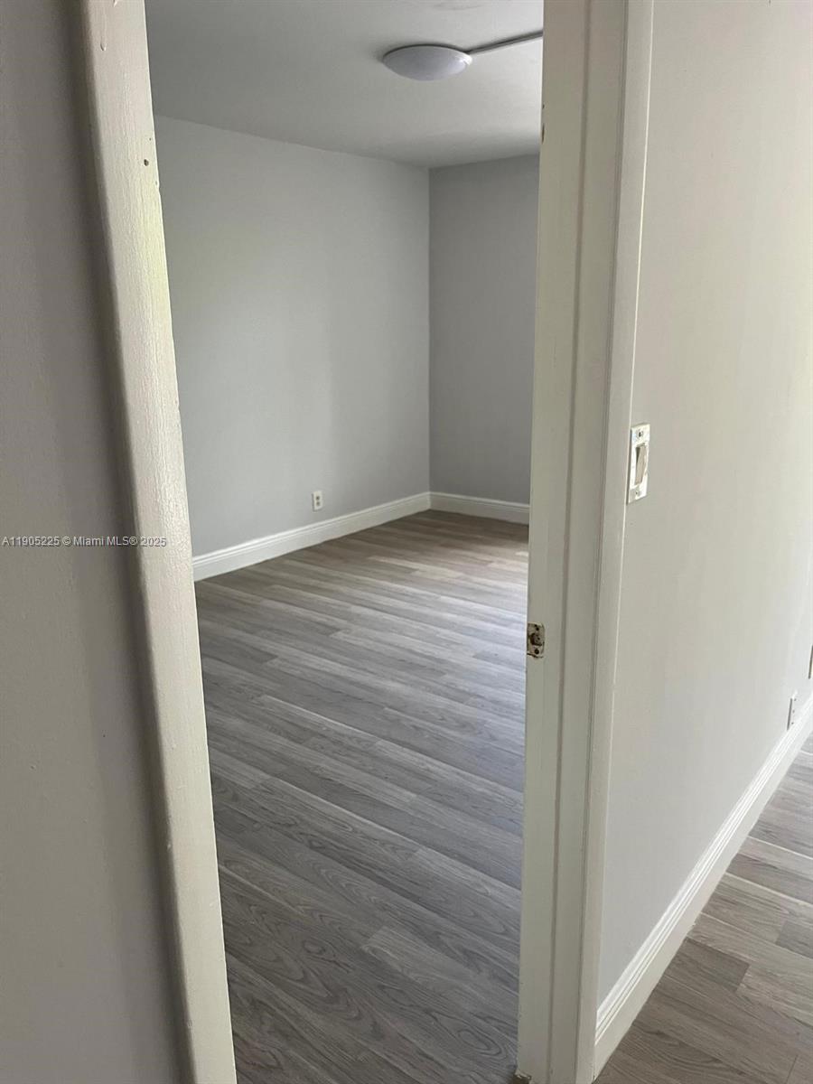 2701 Riverside Drive, Unit 203B Coral Springs, FL 33065 - Photo 8 of 18 a view of hallway with wooden floor
