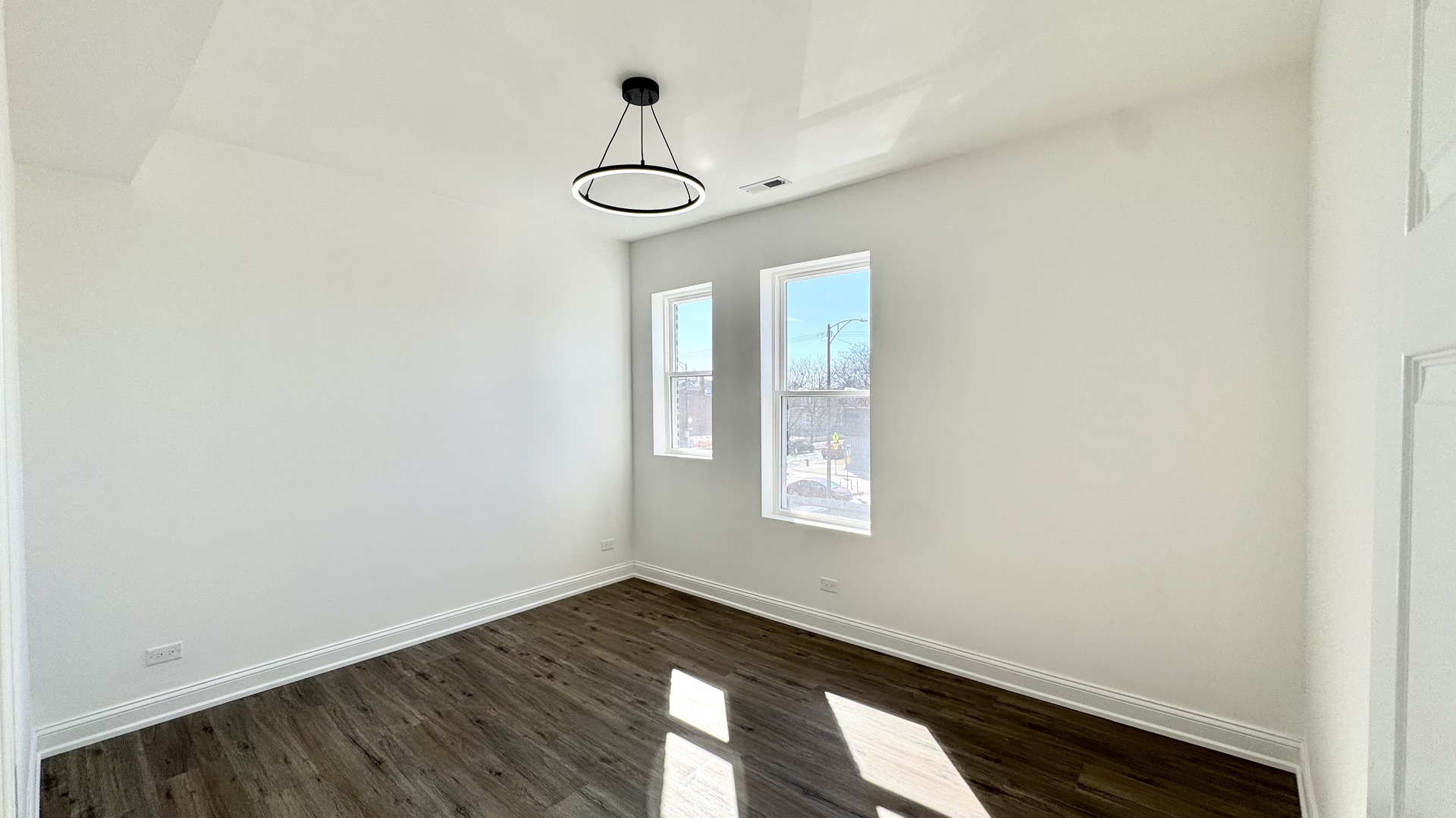 4751 West Monroe Street Chicago, IL 60644 - Photo 17 of 22 an empty room with wooden floor and windows