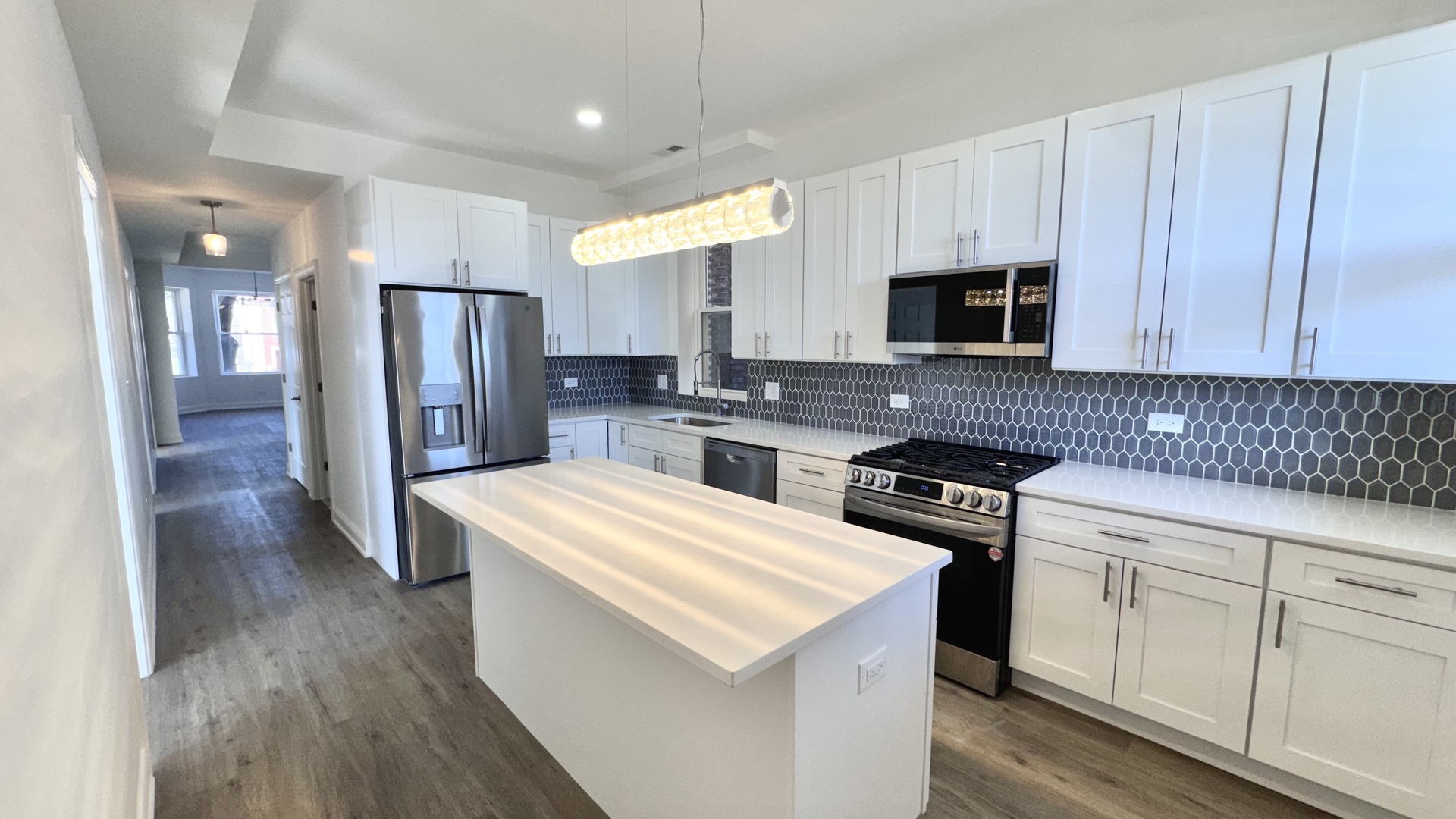 4751 West Monroe Street Chicago, IL 60644 - Photo 18 of 22 a kitchen with stainless steel appliances granite countertop a refrigerator stove microwave and sink