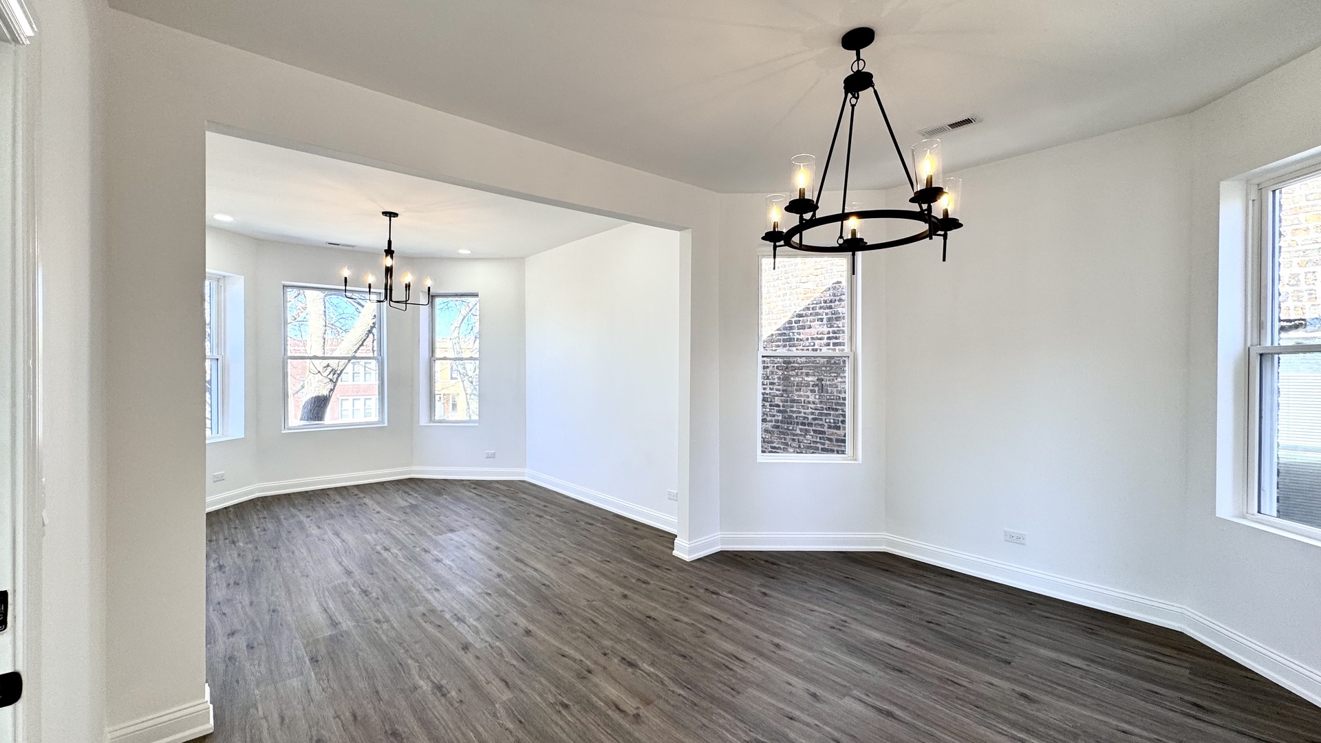 4751 West Monroe Street Chicago, IL 60644 - Photo 6 of 22 a view of empty room with wooden floor and window