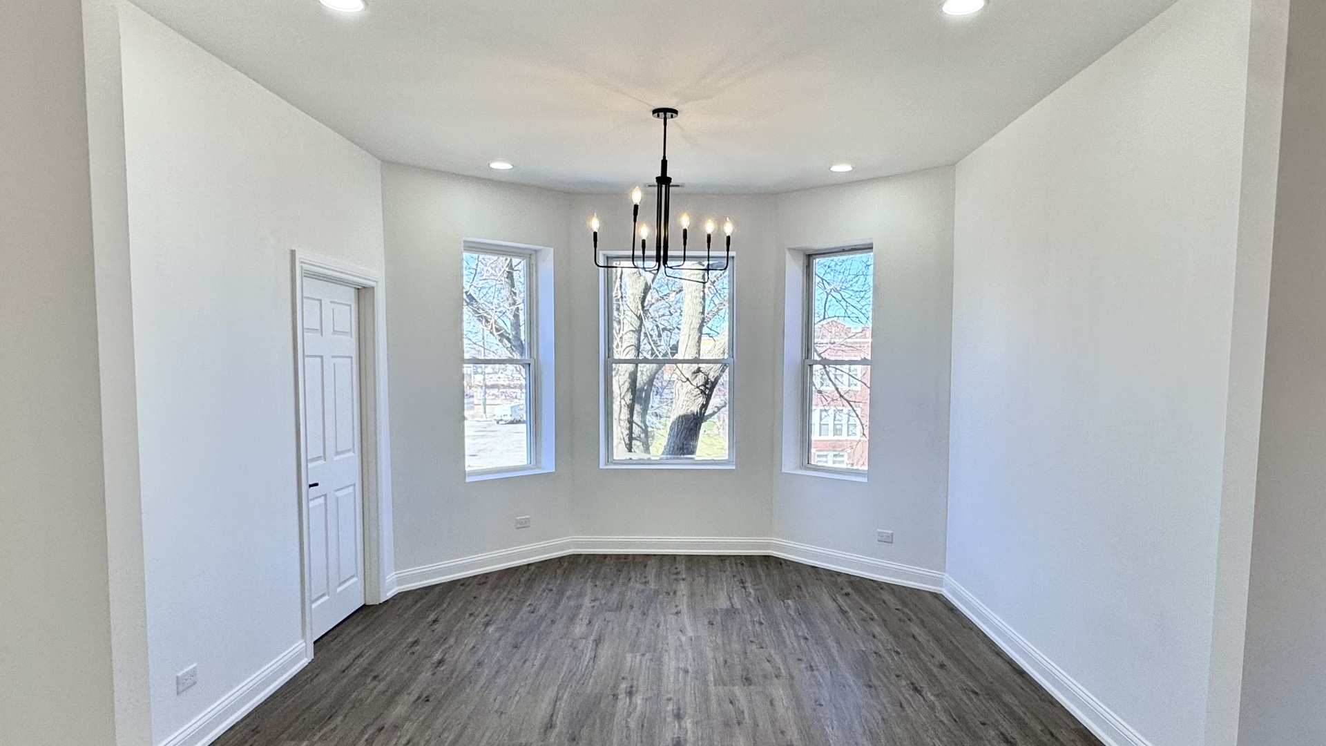 4751 West Monroe Street Chicago, IL 60644 - Photo 7 of 22 a view of an empty room with wooden floor and a window