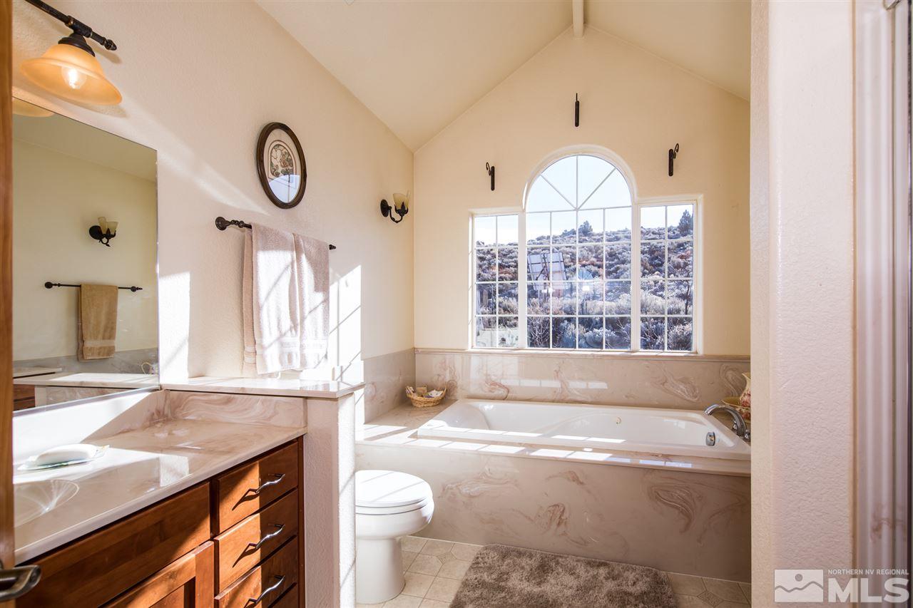 100 Boron Lane Reno, NV 89506 - Photo 15 of 25 a bathroom with a granite countertop sink a toilet and a bathtub