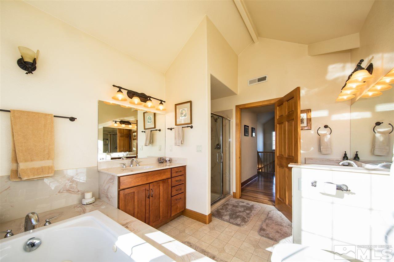 100 Boron Lane Reno, NV 89506 - Photo 16 of 25 a spacious bathroom with a tub sink and mirror