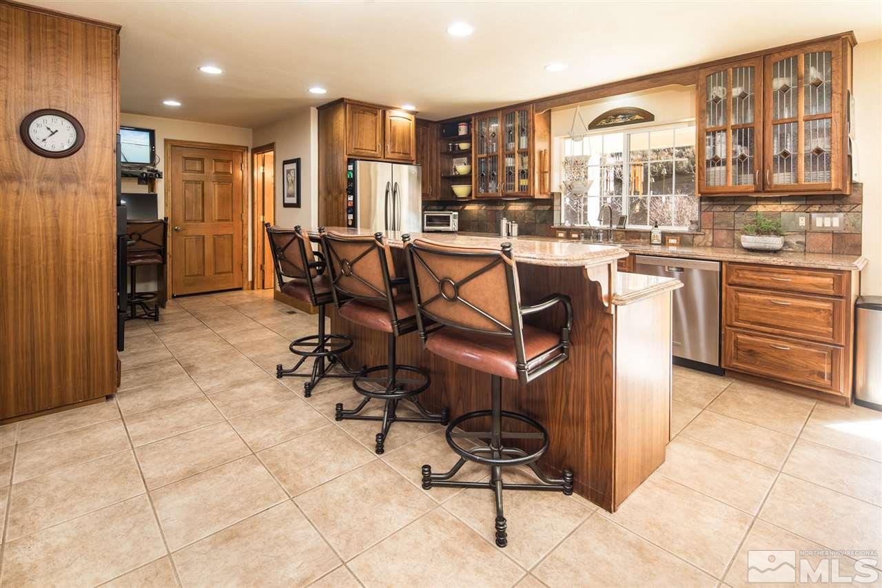 100 Boron Lane Reno, NV 89506 - Photo 6 of 25 a kitchen with stainless steel appliances kitchen island granite countertop a refrigerator and cabinets