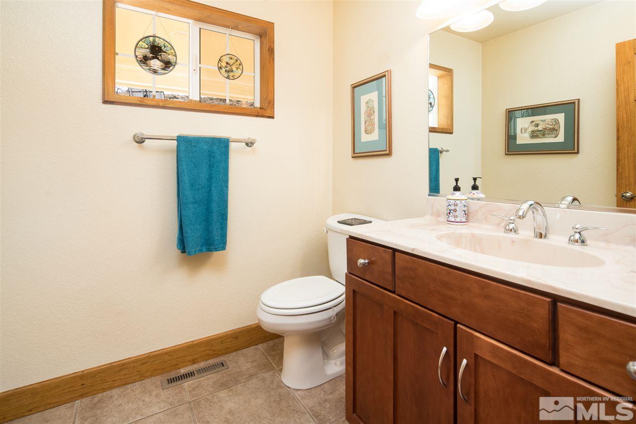 100 Boron Lane Reno, NV 89506 - Photo 9 of 25 a bathroom with a toilet sink and mirror