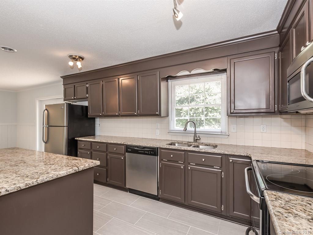 2314 Goldmine Road Monroe, NC 28110 - Photo 14 of 24 a kitchen that has a sink and a stove in it