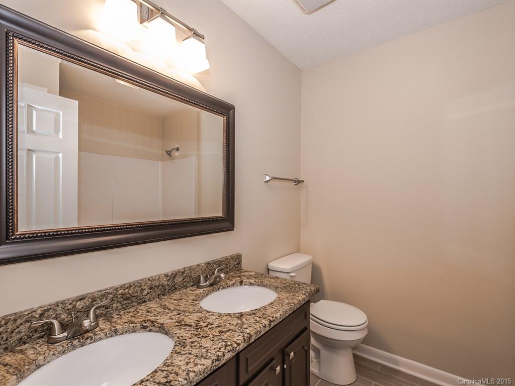 2314 Goldmine Road Monroe, NC 28110 - Photo 19 of 24 a bathroom with a granite countertop sink toilet and mirror