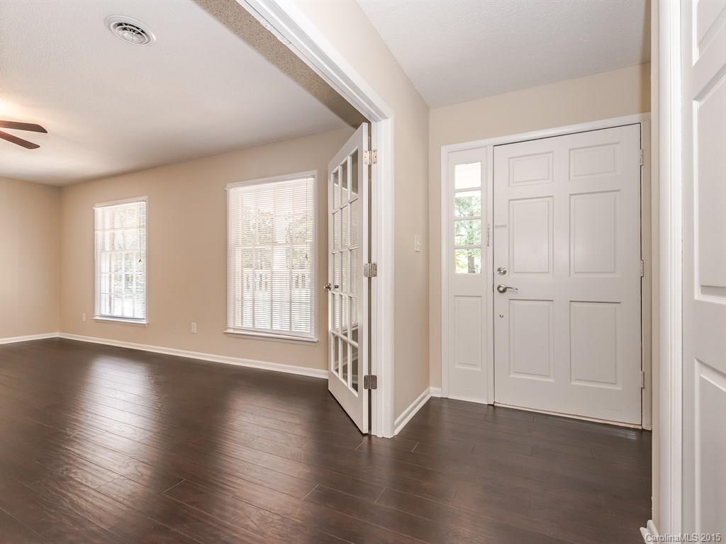 2314 Goldmine Road Monroe, NC 28110 - Photo 4 of 24 an empty room with wooden floor and windows