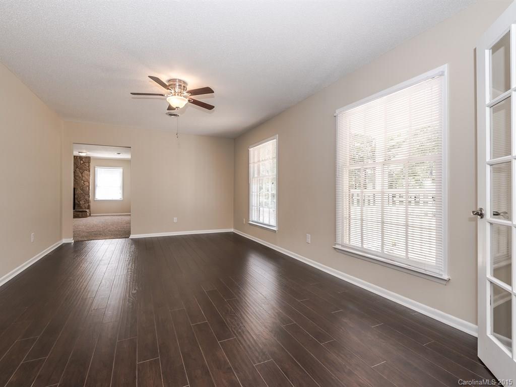 2314 Goldmine Road Monroe, NC 28110 - Photo 6 of 24 a view of an empty room with wooden floor and a window