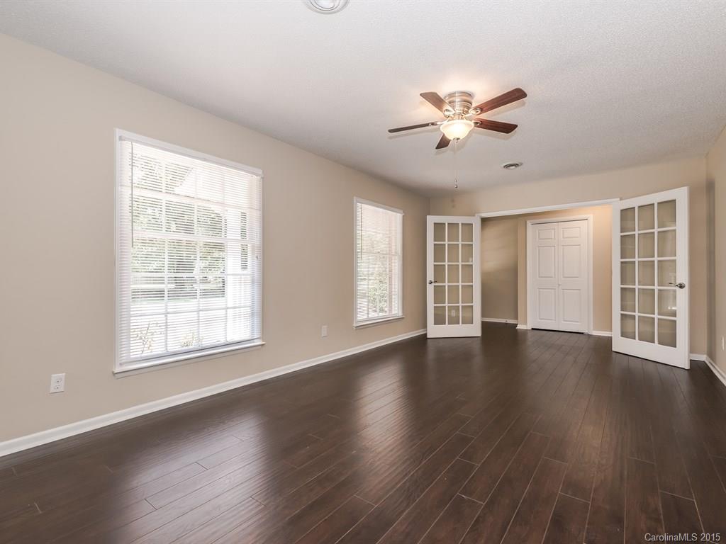 2314 Goldmine Road Monroe, NC 28110 - Photo 7 of 24 a view of an empty room with wooden floor and a window